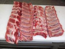 Frozen Pork pieces, feet, ribs, head.